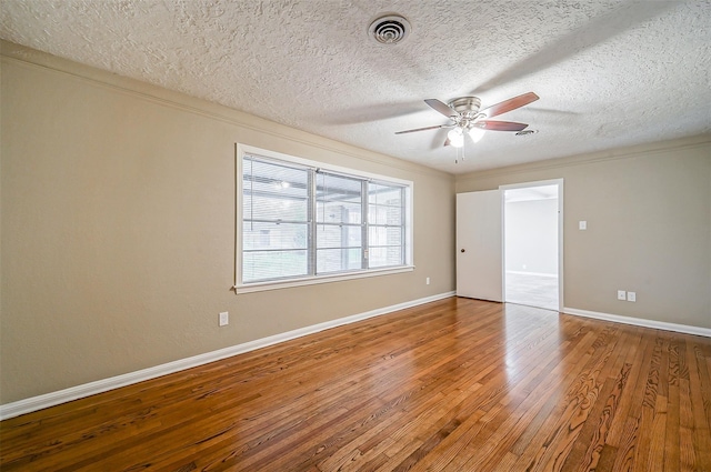 4418 W Pasadena Blvd, Deer Park, TX 77536 - unfurnished bedroom with wood finished floors, a textured ceiling, baseboards, and ceiling fan
