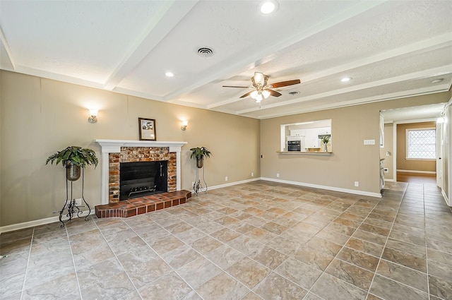 4418 W Pasadena Blvd, Deer Park, TX 77536 - unfurnished living room with a ceiling fan, stone finish flooring, a brick fireplace, baseboards, and beamed ceiling