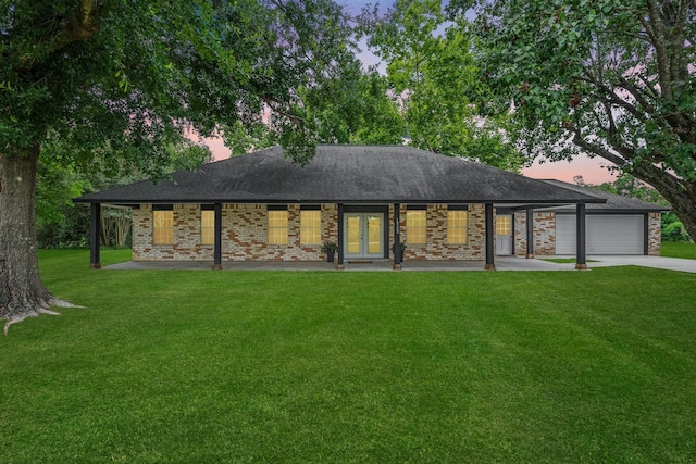 19302 Fisher Dr, Tomball, TX 77377 - back of property featuring a yard, driveway, a garage, french doors, and a shingled roof