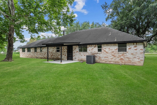 19302 Fisher Dr, Tomball, TX 77377 - back of property featuring a patio, a lawn, cooling unit, brick siding, and roof with shingles