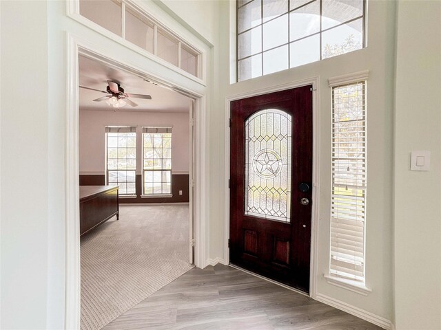 6081 Trent Ct, League City, TX 77573 - foyer entrance featuring a ceiling fan, baseboards, wood finished floors, and carpet floors