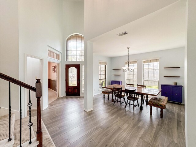 6081 Trent Ct, League City, TX 77573 - entryway with wood finished floors, a chandelier, a high ceiling, stairway, and baseboards