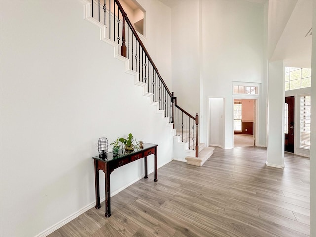 6081 Trent Ct, League City, TX 77573 - foyer entrance featuring a towering ceiling, light wood-style flooring, stairway, and baseboards