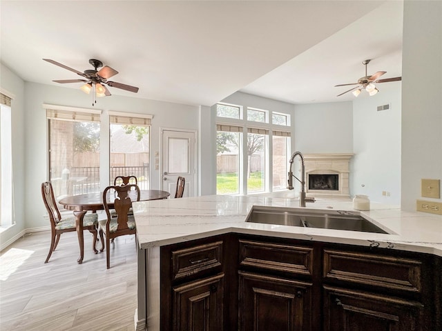 6081 Trent Ct, League City, TX 77573 - kitchen with a sink, plenty of natural light, light stone countertops, and ceiling fan