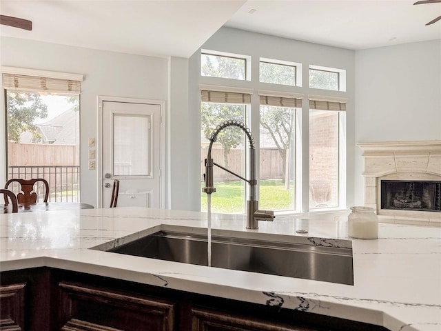 6081 Trent Ct, League City, TX 77573 - kitchen with a sink, healthy amount of natural light, a ceiling fan, and a fireplace