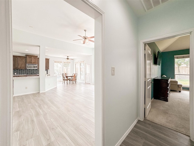 6081 Trent Ct, League City, TX 77573 - hallway with light wood-style floors and baseboards