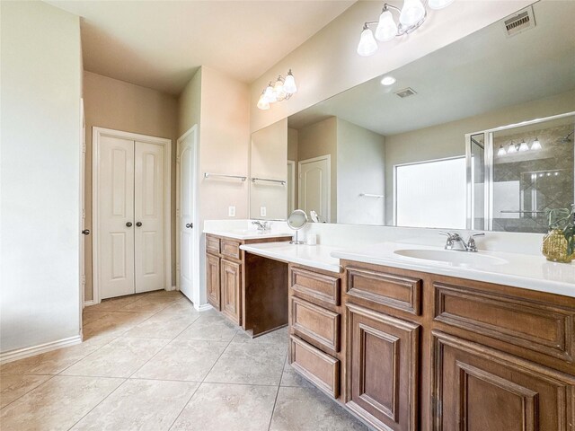 6081 Trent Ct, League City, TX 77573 - bathroom featuring double vanity, tile patterned floors, a shower stall, and baseboards