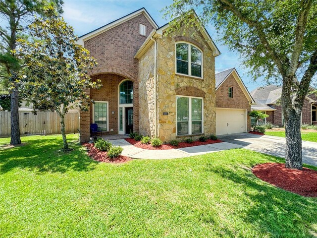 6081 Trent Ct, League City, TX 77573 - traditional-style house featuring stone siding, concrete driveway, and a garage