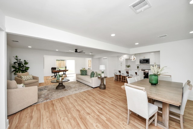 6249 Locke Ln, Houston, TX 77057 - dining room with light wood-style floors, a ceiling fan, and recessed lighting