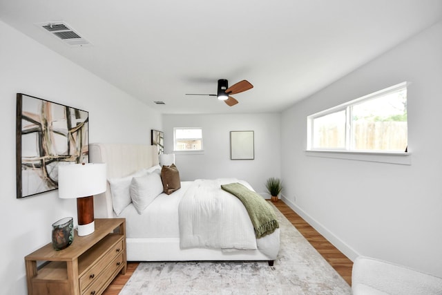 6249 Locke Ln, Houston, TX 77057 - bedroom with wood finished floors, a ceiling fan, and baseboards