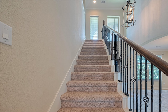20619 Cactus Lake Ln, Richmond, TX 77407 - staircase with crown molding, baseboards, healthy amount of natural light, arched walkways, and a textured wall