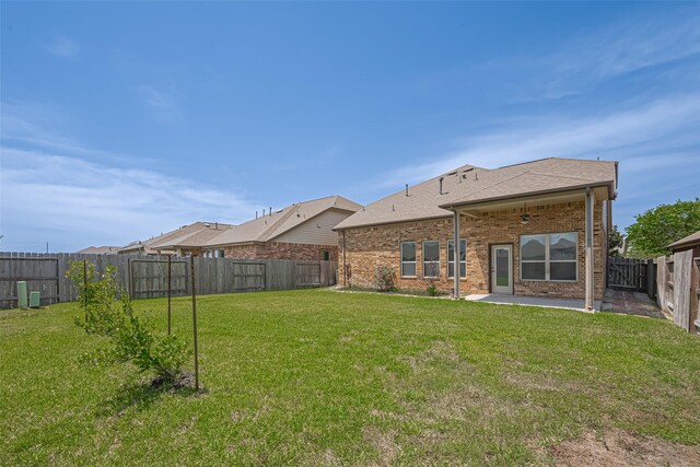 20619 Cactus Lake Ln, Richmond, TX 77407 - back of property featuring a patio area, brick siding, and a shingled roof