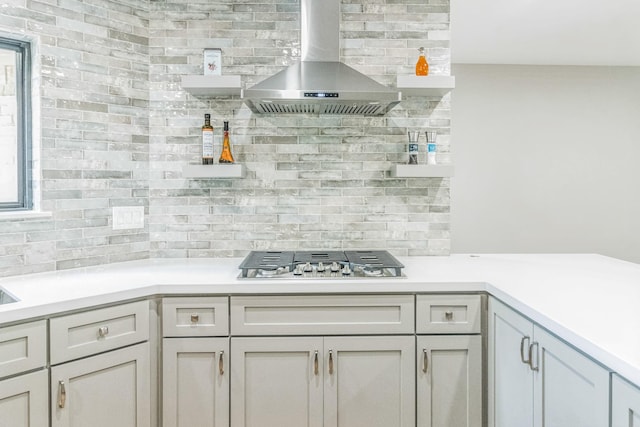 14147 Hillvale Dr, Houston, TX 77077 - kitchen featuring wall chimney exhaust hood, stainless steel gas stovetop, decorative backsplash, and light countertops