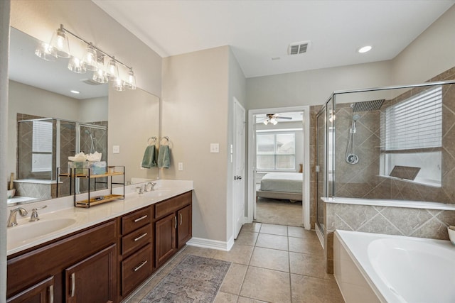 9982 Manor Spring Ln, Brookshire, TX 77423 - ensuite bathroom with double vanity, a bath, a shower stall, tile patterned floors, and baseboards