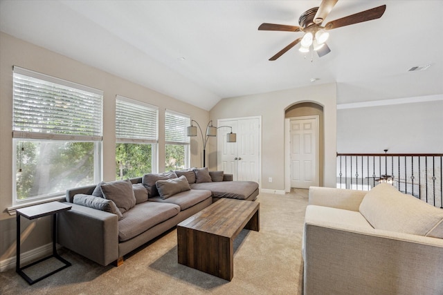9982 Manor Spring Ln, Brookshire, TX 77423 - living room featuring ceiling fan, light carpet, baseboards, arched walkways, and vaulted ceiling