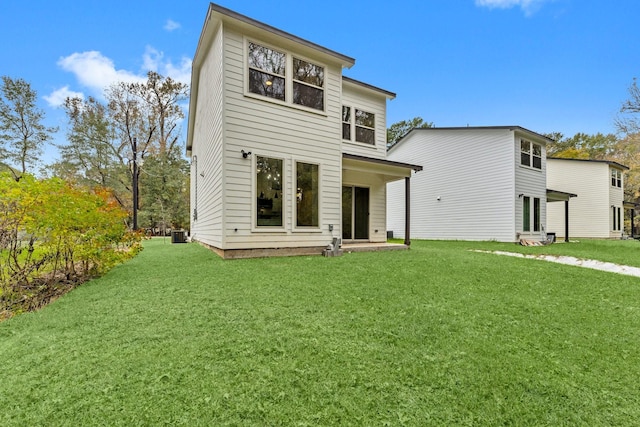 1009 Spokane River Rd, Conroe, TX 77316 - back of property with a lawn and central air condition unit