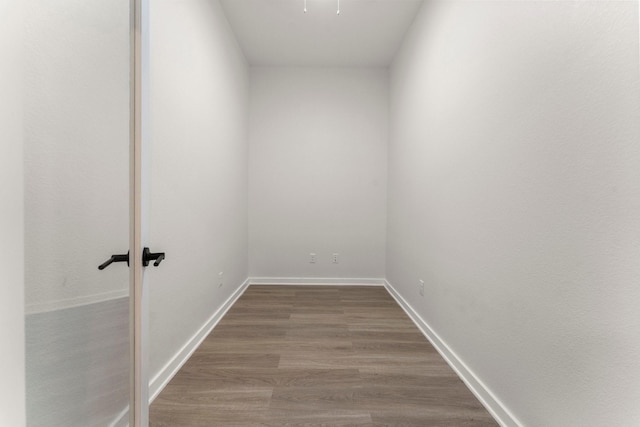 1009 Spokane River Rd, Conroe, TX 77316 - spare room featuring wood finished floors and baseboards