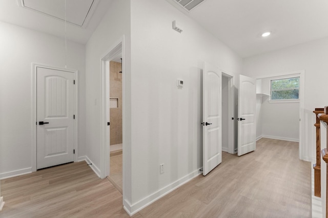1009 Spokane River Rd, Conroe, TX 77316 - corridor with attic access, light wood finished floors, baseboards, and recessed lighting