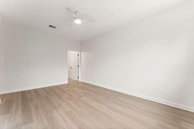 1009 Spokane River Rd, Conroe, TX 77316 - spare room featuring light wood-style floors, a ceiling fan, and baseboards