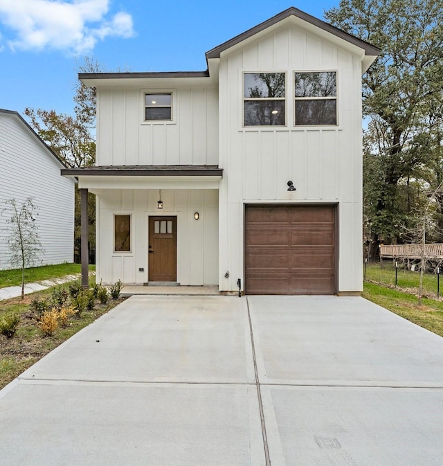 1009 Spokane River Rd, Conroe, TX 77316 - modern farmhouse featuring board and batten siding, a garage, and concrete driveway