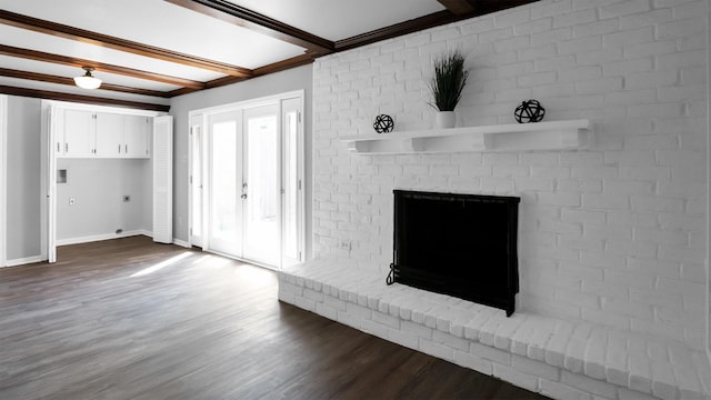 2814 Cambridge Ln, Missouri City, TX 77459 - unfurnished living room featuring dark wood finished floors, baseboards, a brick fireplace, beamed ceiling, and crown molding