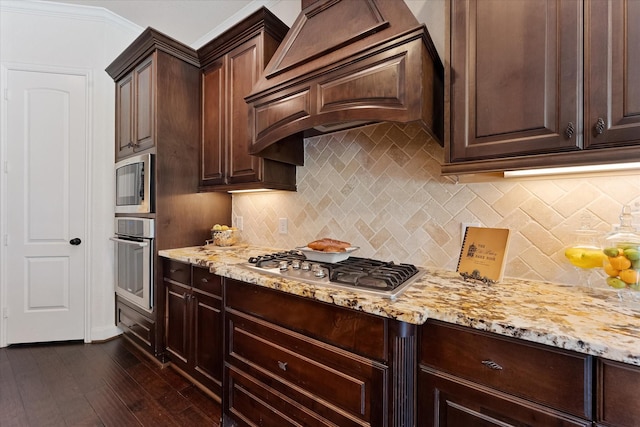 515 Arbor Point Ct, Pinehurst, TX 77362 - kitchen featuring appliances with stainless steel finishes, custom range hood, light stone countertops, and dark brown cabinetry