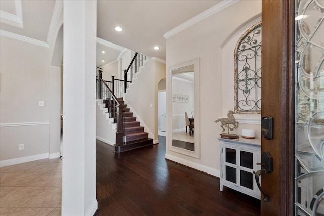 515 Arbor Point Ct, Pinehurst, TX 77362 - entrance foyer featuring arched walkways, ornamental molding, stairway, baseboards, and hardwood / wood-style flooring