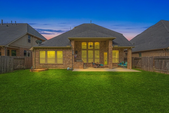 515 Arbor Point Ct, Pinehurst, TX 77362 - back of property at dusk with brick siding, a ceiling fan, a patio, and a shingled roof