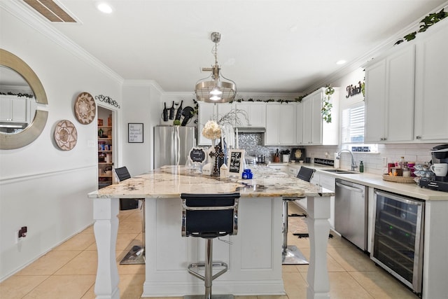 6407 Hillock Ln, Pearland, TX 77584 - kitchen featuring stainless steel appliances, wine cooler, a sink, light tile patterned flooring, and crown molding