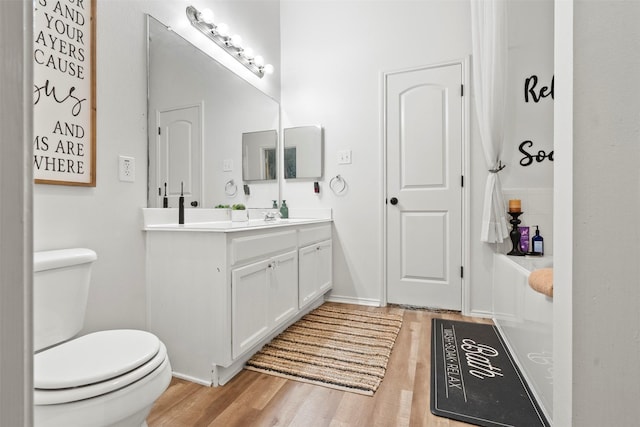 6407 Hillock Ln, Pearland, TX 77584 - full bath with wood finished floors, double vanity, and toilet