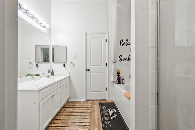 6407 Hillock Ln, Pearland, TX 77584 - bathroom with vanity, a garden tub, wood finished floors, and a shower