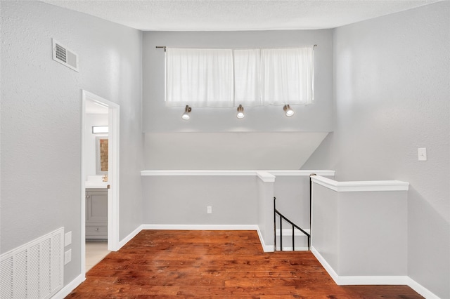 12900 Walden Rd Unit 406D, Montgomery, TX 77356 - hallway featuring an upstairs landing, wood finished floors, and baseboards