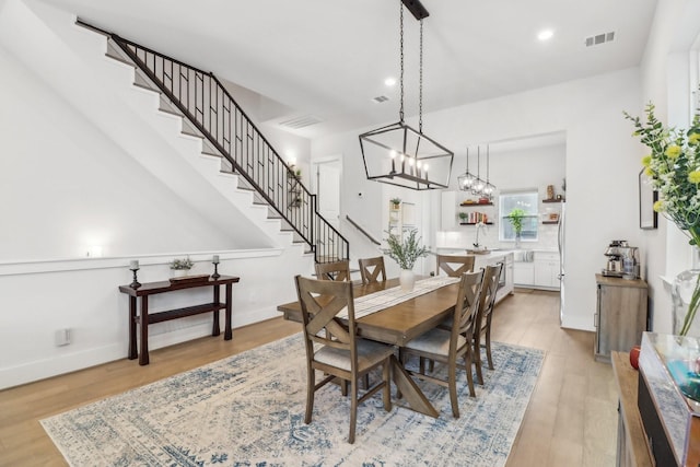 1234 W 21st St, Houston, TX 77008 - dining space with stairway, light wood-type flooring, recessed lighting, a chandelier, and baseboards