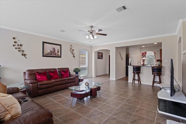 3418 Quarry Place Ln, Katy, TX 77493 - living room featuring dark tile patterned flooring, crown molding, arched walkways, and ceiling fan