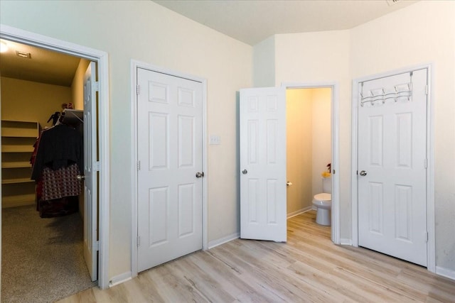 3418 Quarry Place Ln, Katy, TX 77493 - unfurnished bedroom featuring light wood-style floors and a spacious closet