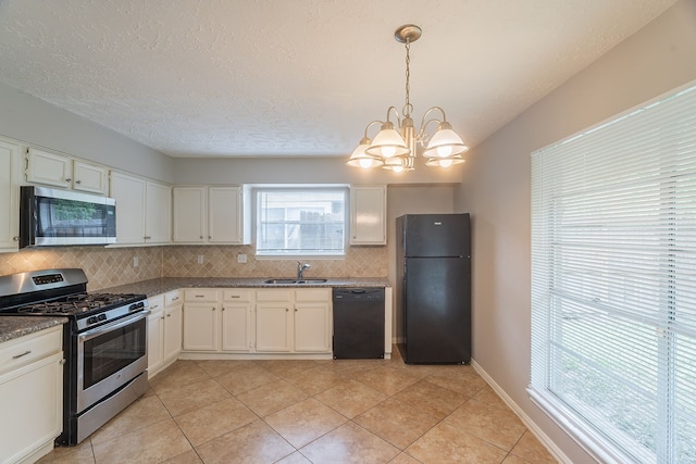11714 Welshpool Glen Dr, Houston, TX 77066 - kitchen with black appliances, a sink, tasteful backsplash, a chandelier, and light tile patterned floors