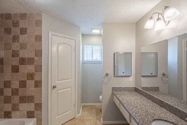 11714 Welshpool Glen Dr, Houston, TX 77066 - bathroom featuring vanity, toilet, a textured ceiling, baseboards, and tub / shower combination