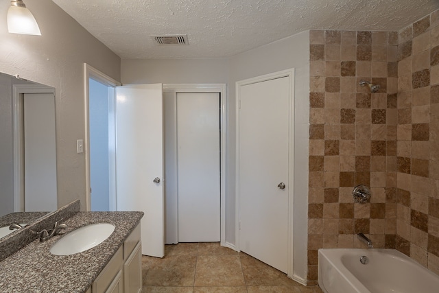 11714 Welshpool Glen Dr, Houston, TX 77066 - full bathroom with vanity, a textured ceiling, shower / bath combination, and tile patterned floors