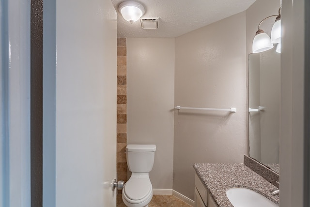 11714 Welshpool Glen Dr, Houston, TX 77066 - bathroom featuring vanity, toilet, a textured ceiling, and baseboards