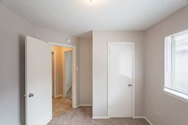 11714 Welshpool Glen Dr, Houston, TX 77066 - unfurnished bedroom with multiple windows, light carpet, and baseboards