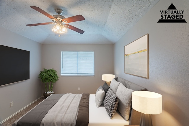 11714 Welshpool Glen Dr, Houston, TX 77066 - carpeted bedroom featuring a textured ceiling, a ceiling fan, baseboards, and lofted ceiling