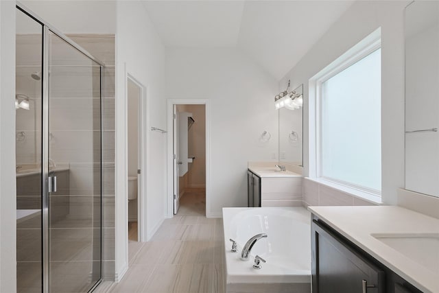 27519 Beachside Arbor Dr, Katy, TX 77493 - full bath featuring two vanities, a stall shower, a garden tub, vaulted ceiling, and toilet