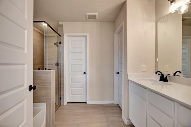 418 Kendall Crest Dr, Alvin, TX 77511 - bathroom featuring vanity, a stall shower, wood finished floors, and baseboards