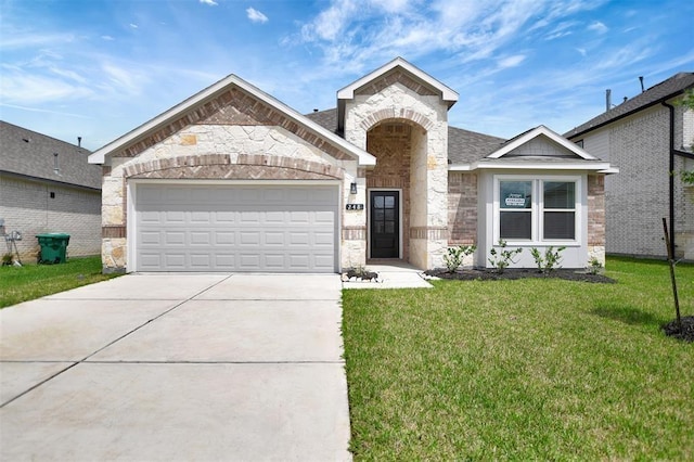 418 Kendall Crest Dr, Alvin, TX 77511 - view of front of home with stone siding, driveway, a garage, and a front lawn