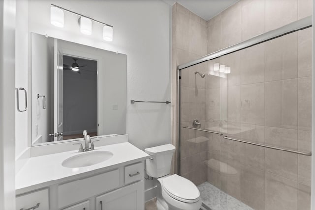 26915 Longwood Ledge Dr, Spring, TX 77389 - bathroom featuring toilet, vanity, a stall shower, and ceiling fan