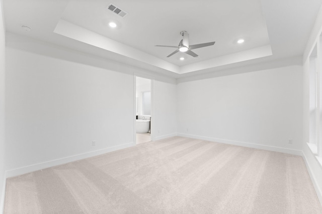 26915 Longwood Ledge Dr, Spring, TX 77389 - unfurnished room featuring a tray ceiling, a ceiling fan, recessed lighting, light colored carpet, and baseboards