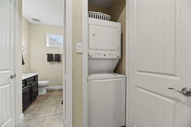 15702 Belmar Heights Dr, Cypress, TX 77429 - laundry room with stacked washing machine and dryer and baseboards