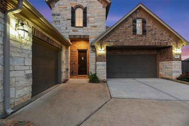15702 Belmar Heights Dr, Cypress, TX 77429 - french country home featuring concrete driveway, a garage, and stone siding