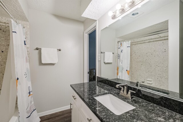 16011 Southampton Dr, Spring, TX 77379 - full bath featuring vanity, wood finished floors, and baseboards