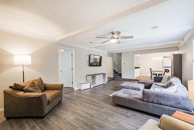 16011 Southampton Dr, Spring, TX 77379 - living room featuring stairway, a textured ceiling, wood finished floors, crown molding, and baseboards